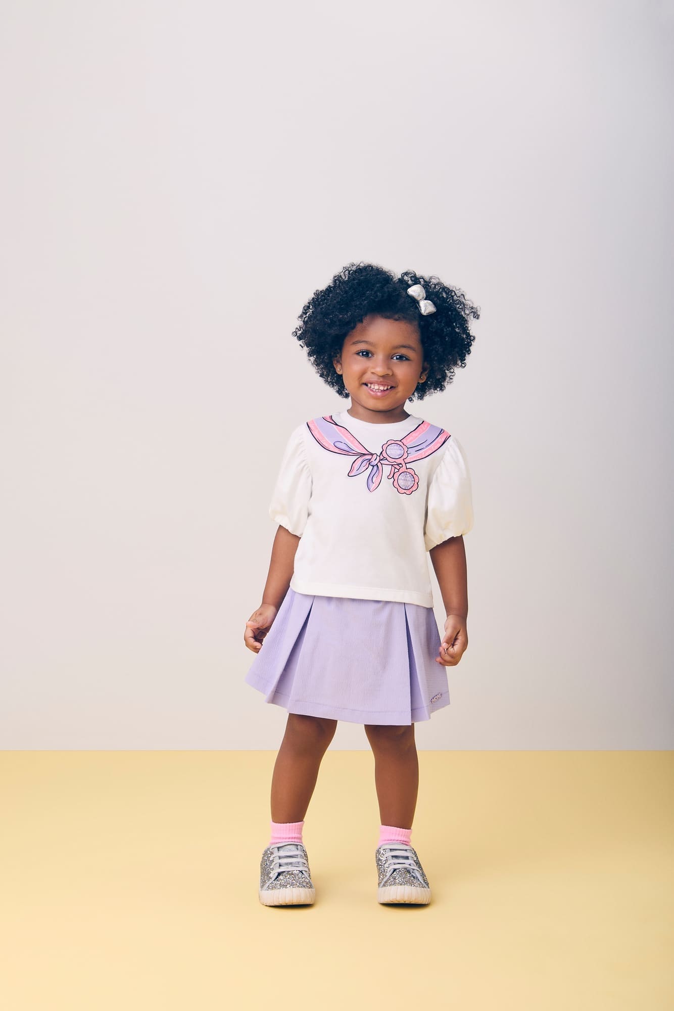 Conjunto Infantil Momi Verão com Shorts Saia Lilás e Blusa Branca Laço