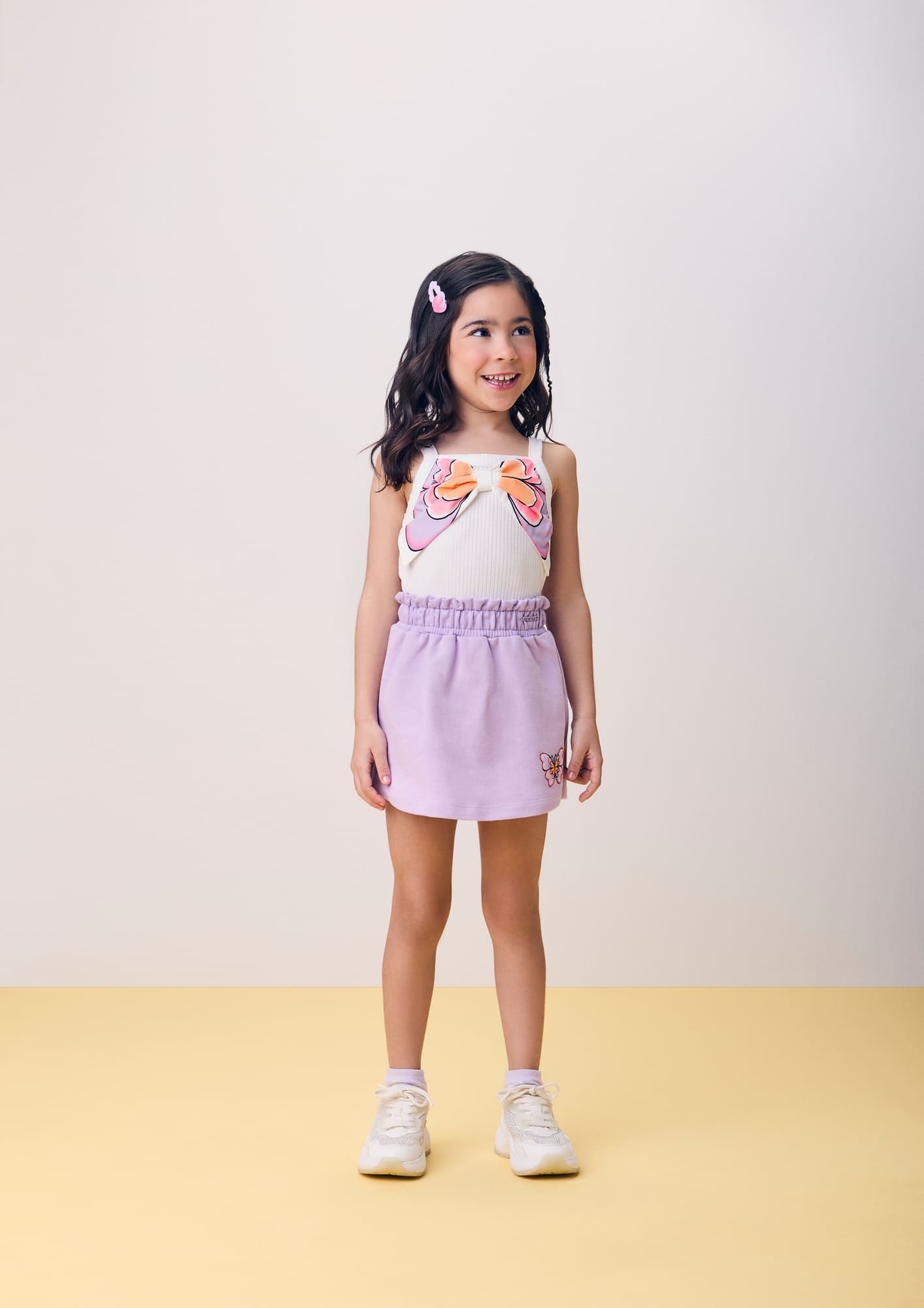 Conjunto Infantil Momi Verão com Shorts Saia Lilás e Regata Branca Lacinho Borboleta